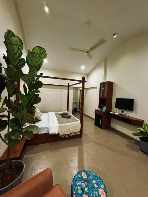 Bedroom with four-poster bed and plants at The Seascape